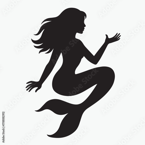 Black silhouette of a mermaid swimming underwater with her tail