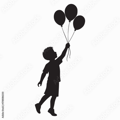 Silhouette of a child releasing colorful balloons into the sky
