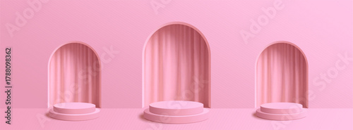 A soft pink backdrop showcases three pedestals with draped curtains in arched niches creating an elegant display.