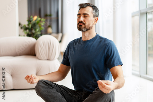 Tableau sur toile Man meditating at home finding inner balance