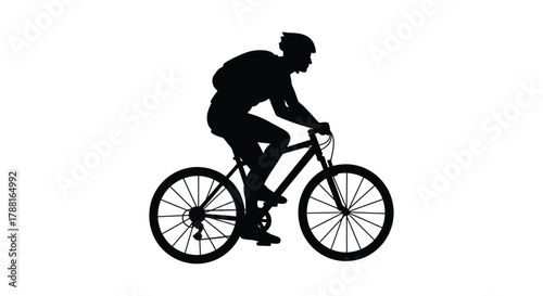 Silhouette of a cyclist riding a mountain bike outdoors