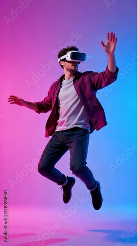Energetic Man Jumping in Virtual Reality Headset on Vibrant Neon Gradient Background