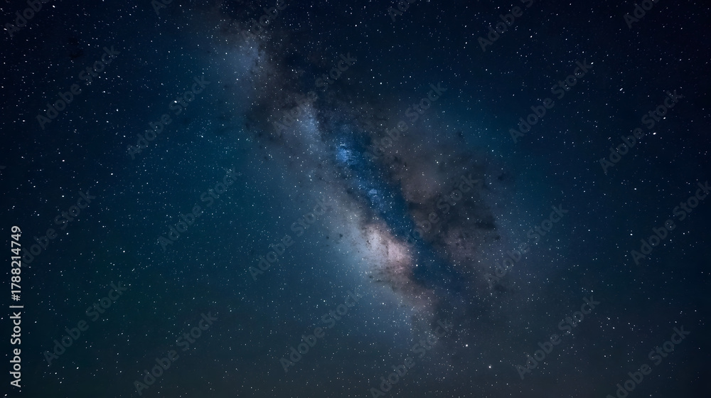 Naklejka premium Vibrant cosmic dust lanes and glowing stars of the Milky Way galaxy shining brightly in the deep night sky