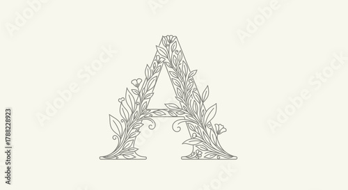 Elegant letter A monogram adorned with delicate floral and foliage elements on soft beige backdrop