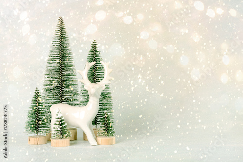 White Christmas reindeer and Christmas trees with copy space for text. Christmas concept background