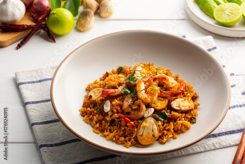 Photos Tom Yum Fried Rice,Thai fried rice with shrimp and Straw mushroom with tom yum sauce in white plate