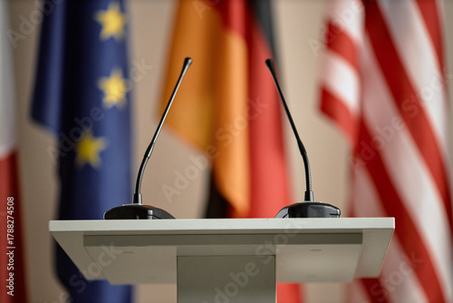 Konstfotografi Empty podium with two microphones standing in front of blurred European Union, G
