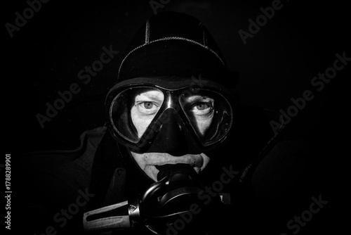 scuba diver in mask on black background