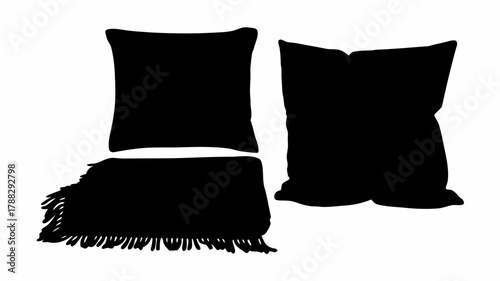 Silhouette of two pillows and a fringed blanket creating a cozy and inviting home atmosphere scene