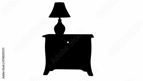 Silhouette of a lamp on a nightstand with a drawer and a bulbous lamp base in a simple black and white image