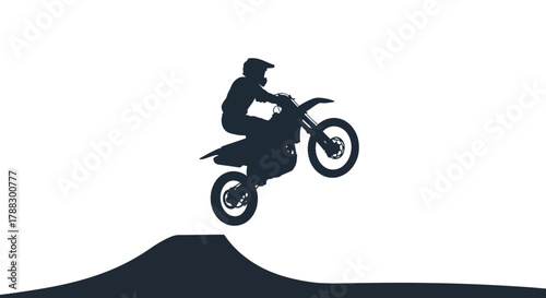 A motorcyclist jumps off a dirt mound midair in silhouette against a white background