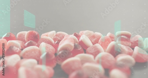 Displaying pile of sugar-coated gummy candies showing sugar crystals on table in studio, mint flare