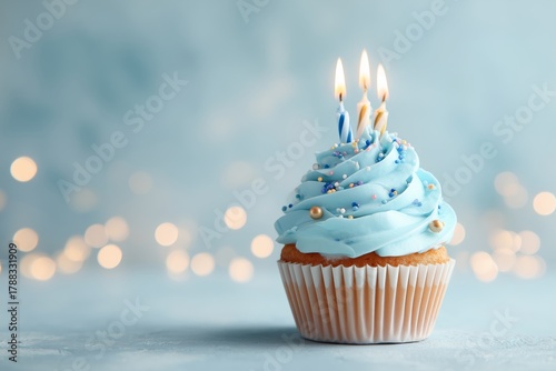Delicious Birthday Cupcake With Candles and Blue Frosting on a Festive Backgr...