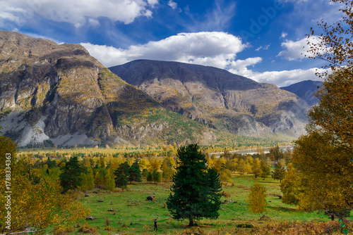 Autumn mountains with clouds at sunset. Altai mountains, Siberia, Russia. Beautiful autumn landscape.