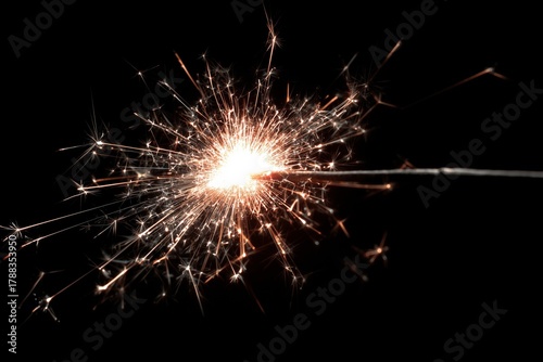 Sparkler Creates Bright and Colorful Light in Dark Background During Celebrat...