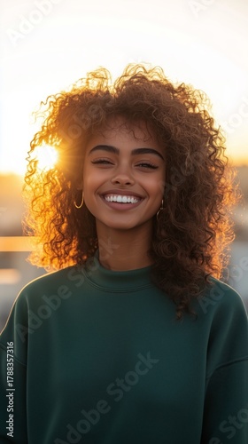 Young Woman Smiles Warmly During Sunset in a City Street