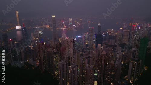 Wallpaper Mural Soft dusk spreads across tall blocks while harbour reflects mixed colour. Ferries move slowly and ridges fade behind highrises as windows light up and narrow Hong Kong pulse Torontodigital.ca
