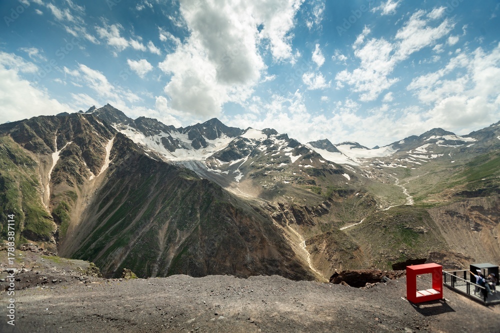 Fototapeta premium Winter landscape snow-capped mountains bathed in morning. Snow valleys below.