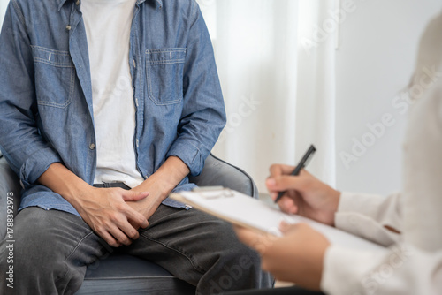 Bild auf Leinwand Man hold hand in front of private parts feeling discomfort and consult doctor