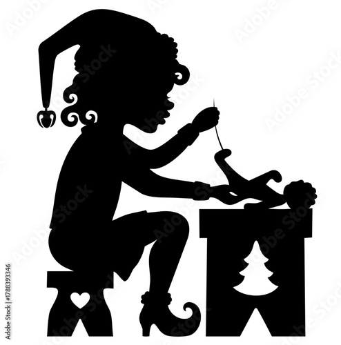 Christmas elf  silhouette sits at a workbench, sewing a toy by hand, creating miracles in Santa's, North Pole workshop.