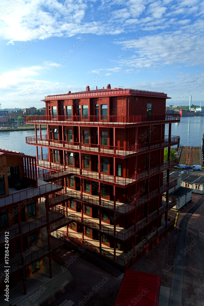 Fototapeta premium Sustainable cabins with natural materials on waterfront in Kvillepiren, Hisingen, sunny day, Gothenburg, Sweden
