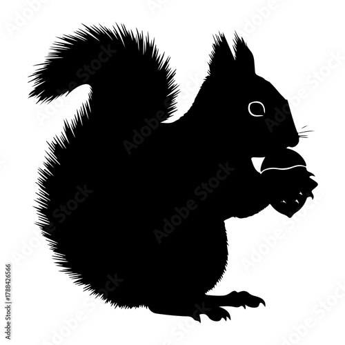 Black silhouette of a squirrel holding a nut acorn