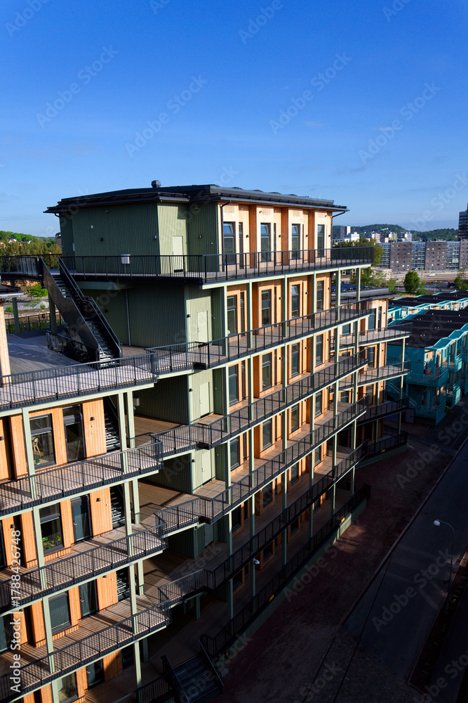 Fototapeta premium Sustainable cabins with natural materials on waterfront in Kvillepiren, Hisingen, sunny day, Gothenburg, Sweden