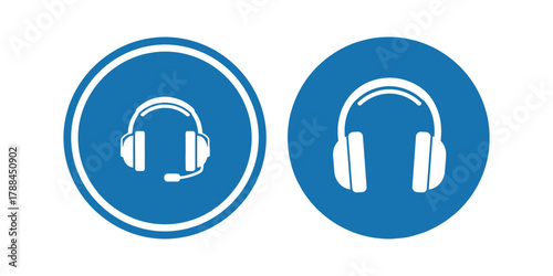 Two blue oval safety signs with white icons of headphones indicating hearing protection required in an industrial environment