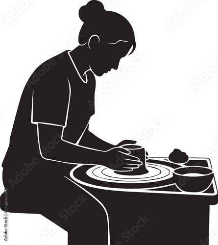 Woman concentrates on shaping clay on a potter's wheel creating handmade art