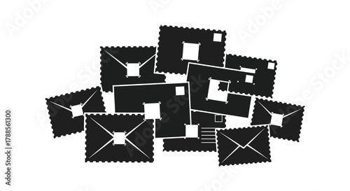 Pile of black and white postage stamps with perforated edges in a chaotic arrangement