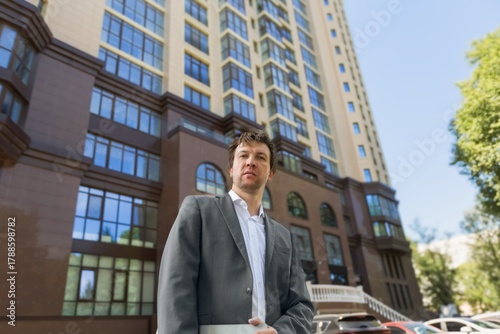 Wallpaper Mural Real estate male agent posing outdoors. Torontodigital.ca