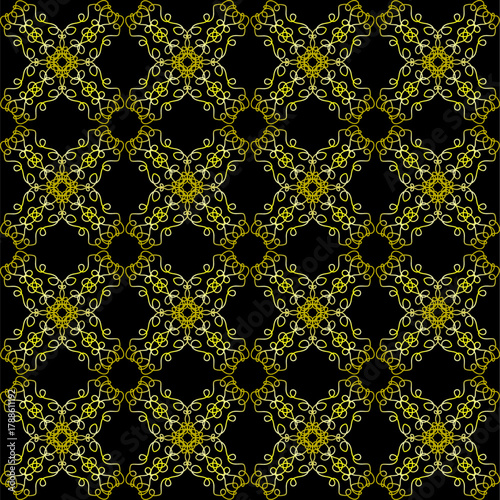 A yellow lace pattern on a black background. Seamless texture for fabric or wallpaper.