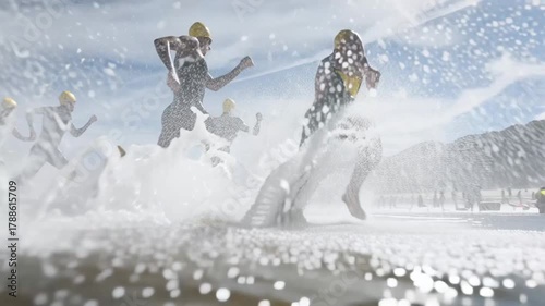 Group of focused triathletes wearing helmets run through shallow sea water at dawn splashing waves as they begin competition showing teamwork energy and determination