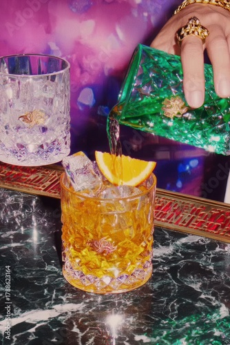 Pouring Orange Cocktail into Crystal Glass, Party Atmosphere