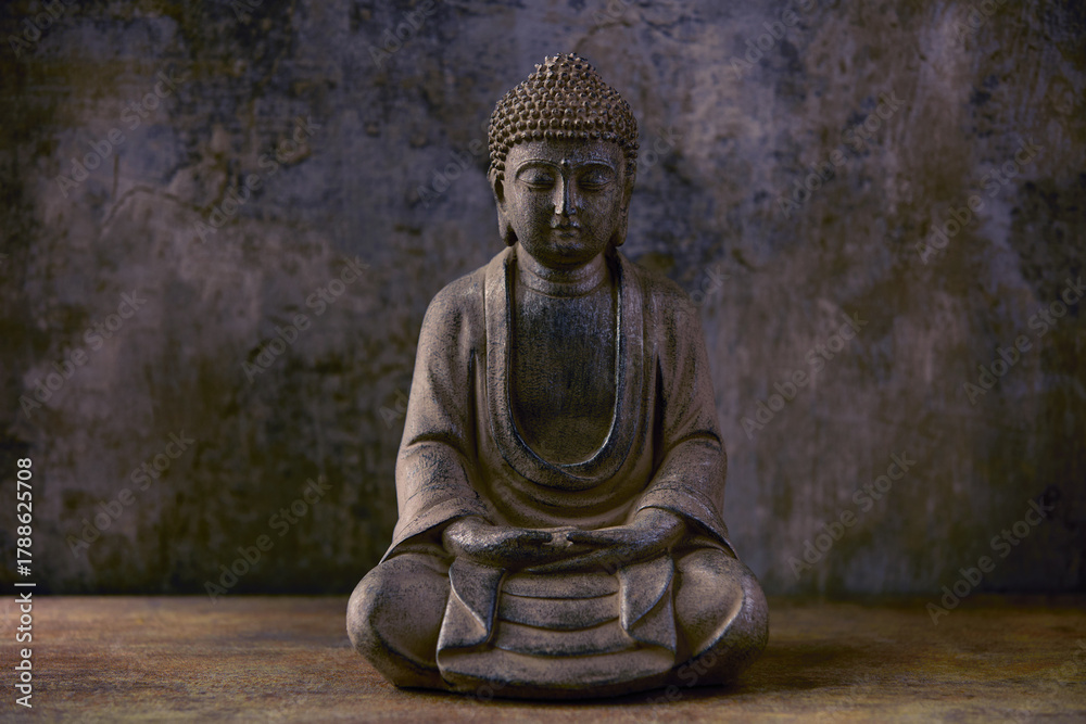 Obraz premium Meditating Buddha Statue on dark background. Soft focus. Close up. Copy space 