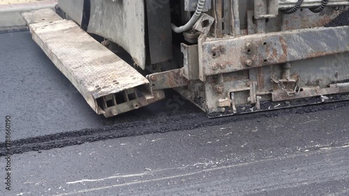 Construction of asphalt roads using an asphalt paver