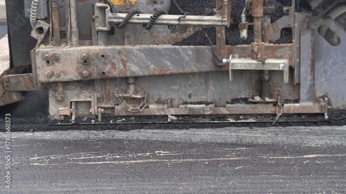 Construction of asphalt roads using an asphalt paver