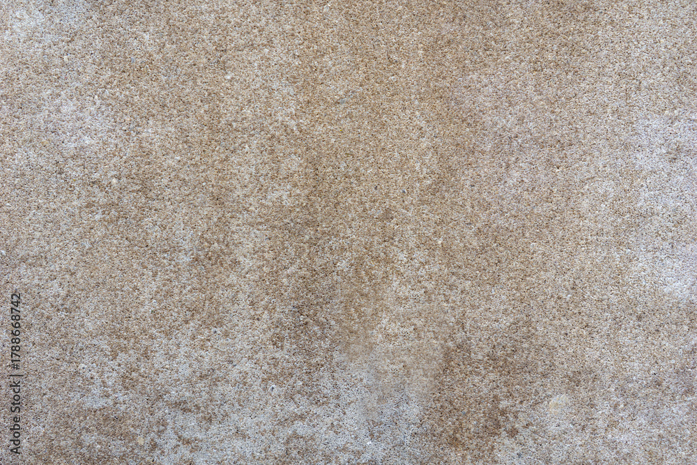 Fototapeta premium full frame close up of a beige speckled concrete surface showing uniform grainy texture for construction, architecture, and concept of interior design