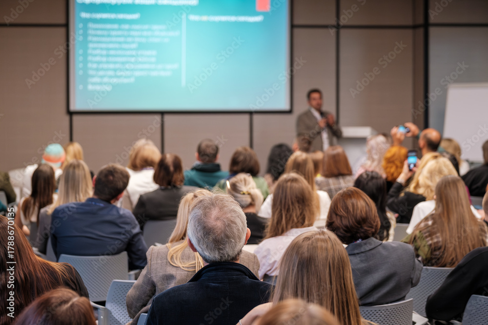 custom made wallpaper toronto digitalEngaged audience at business conference listening to speaker in modern lecture hall with projector screen