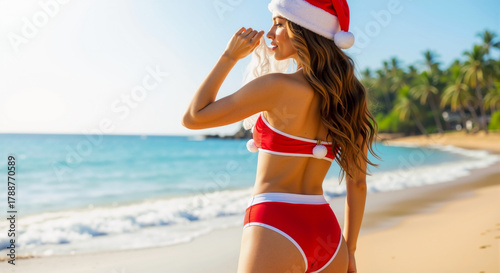 Caucasian woman in Santa hat and red bikini on tropical beach with ocean and palm trees, Christmas holiday vacation and summer travel lifestyle banner with copy space