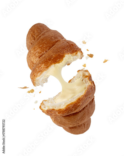 Croissant with vanilla cream falling on white isolated background