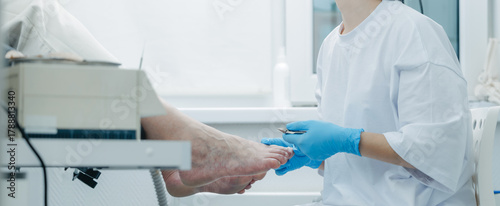 Quadro su tela Podiatrist performing foot care procedure on caucasian elder female patient in c