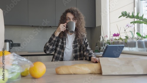 Relaxed Woman Having Morning Coffee And Reading On Laptop At Home