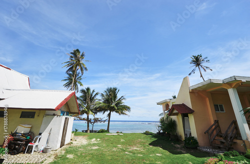 Photography Tropical Seaside Houses with Palm Trees and Bright Blue Sky