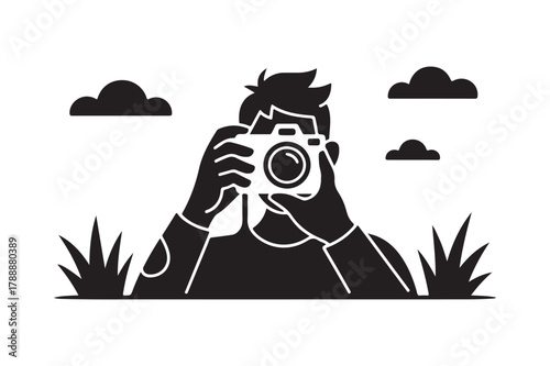 Silhouette of a person taking a photo with a camera outdoors