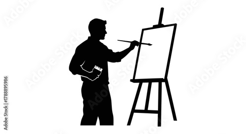 Silhouette of an artist painting on a canvas on an easel