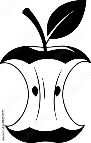 Black apple core with stem and one leaf remains after being partially eaten
