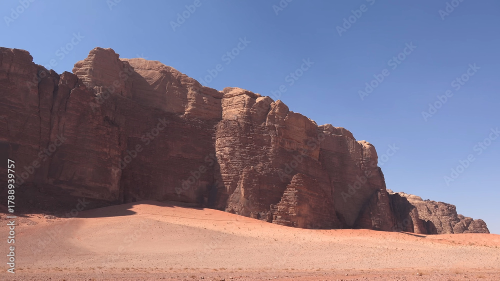 Fototapeta premium A trip to Wadi Rum desert in Jordan. Beautiful african travel photo. Sandy landscapes, mountains, rocks, dunes, and nature. Summer vacation in arab country. Moon Valley. Martian desert.