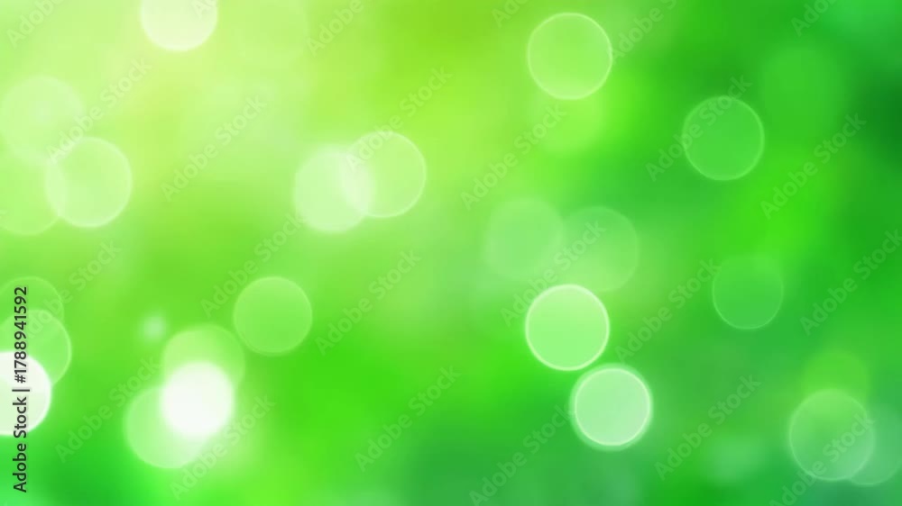 Vibrant green bokeh background with shimmering light circles, creating a fresh and luminous abstract texture perfect for nature, spring, or clean design concepts.
