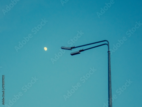 Moon in the sky opposite the lantern